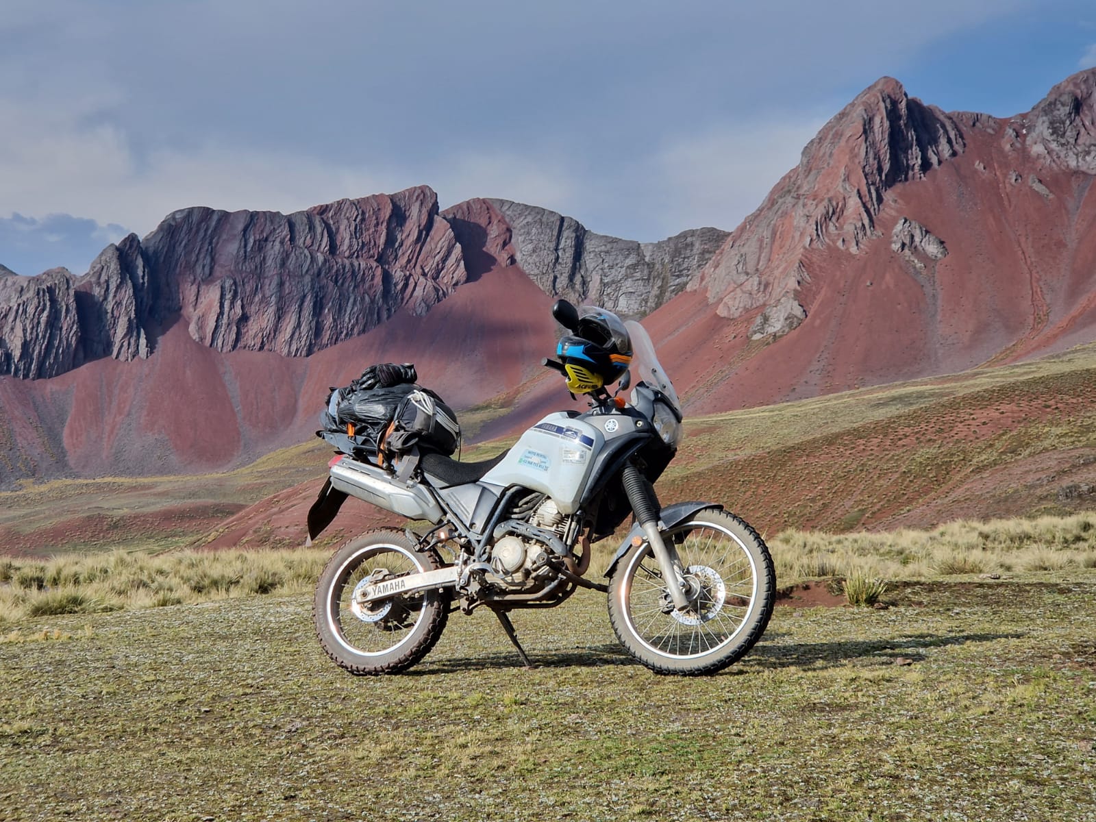 Blue dual-sport motorcycle parked on a scenic road