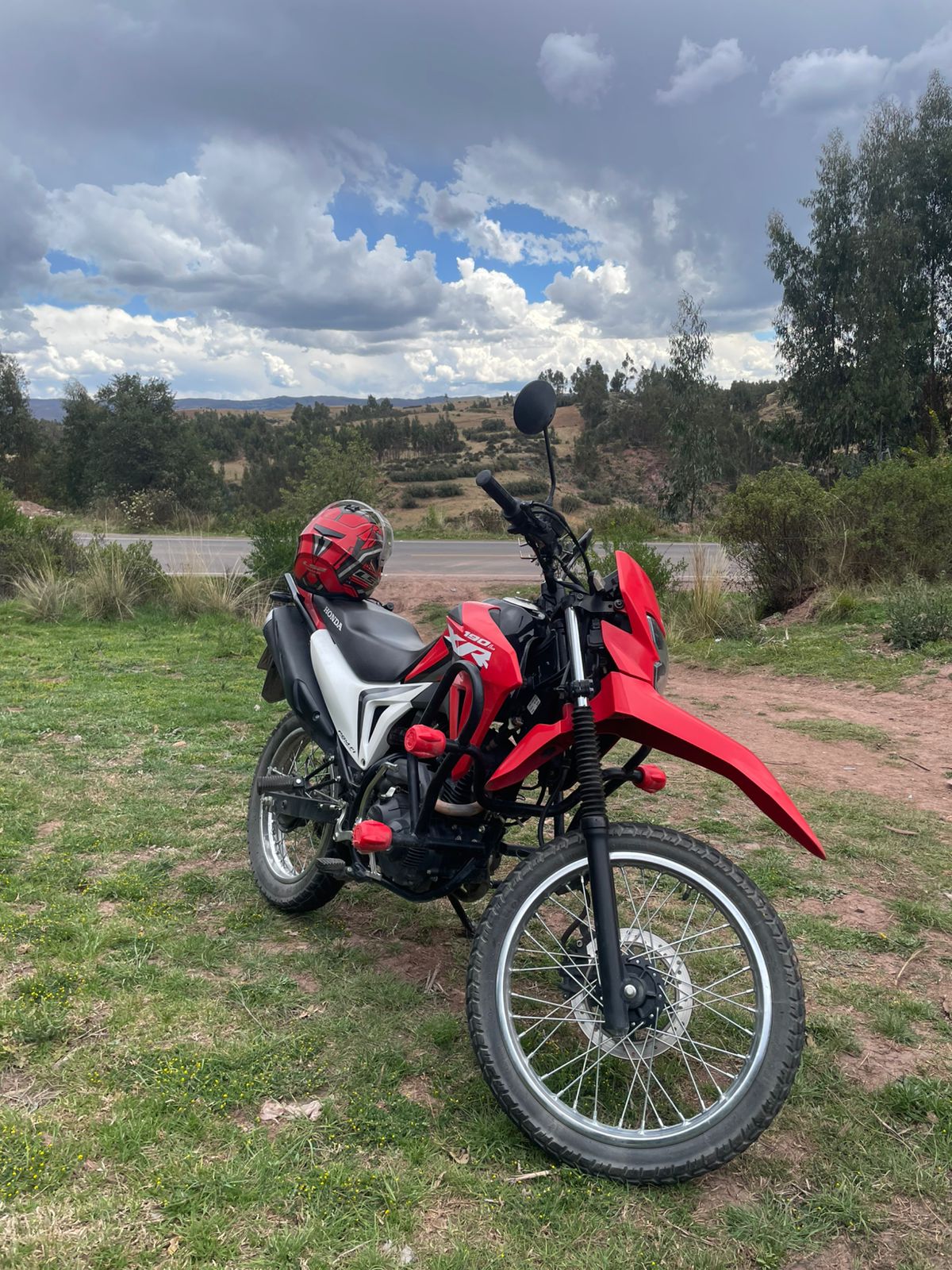 Blue dual-sport motorcycle parked on a scenic road