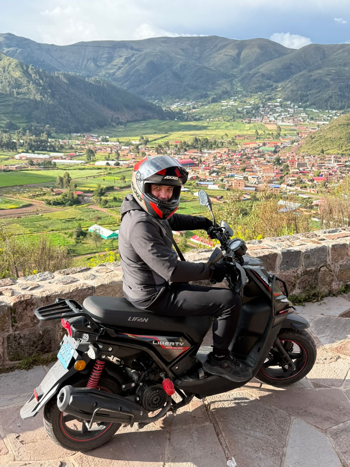 Blue dual-sport motorcycle parked on a scenic road